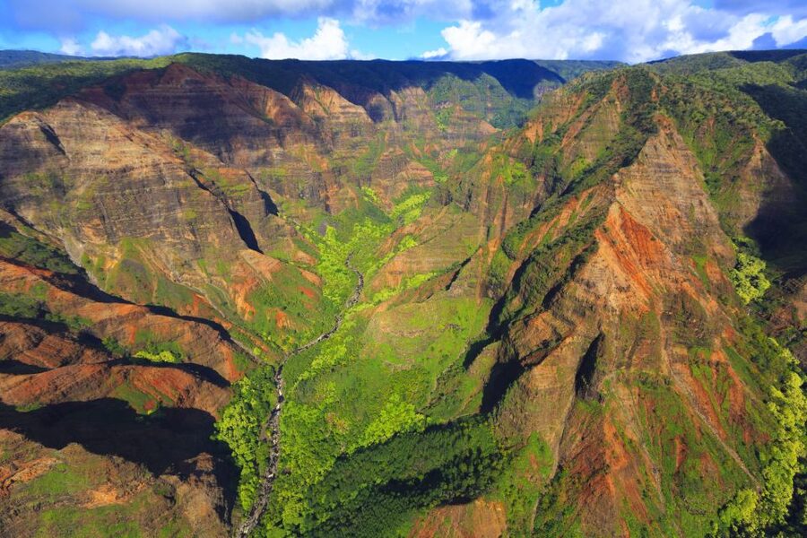 Lihue: Deluxe Waterfall Safari Helicopter Tour - First stop: Na Pali Coast cliffs, scale, and photo angles